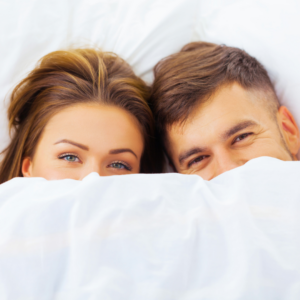 couple happy in bed after using HRT