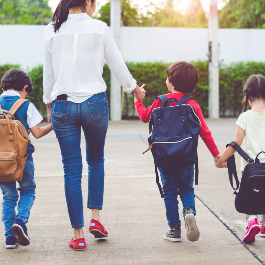 mom walking children back to school