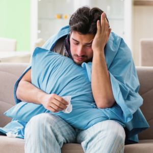 man sick with a virus on couch