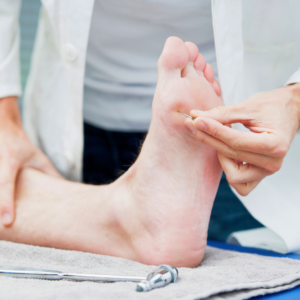 doctor examining foot of neuropathy patient